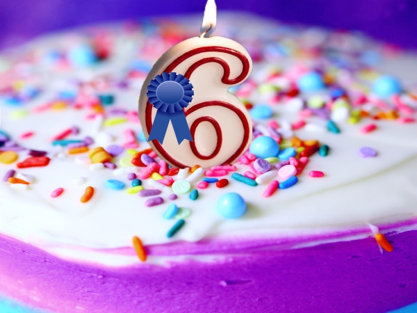 Birthday cake with 6 candle and blue ribbon